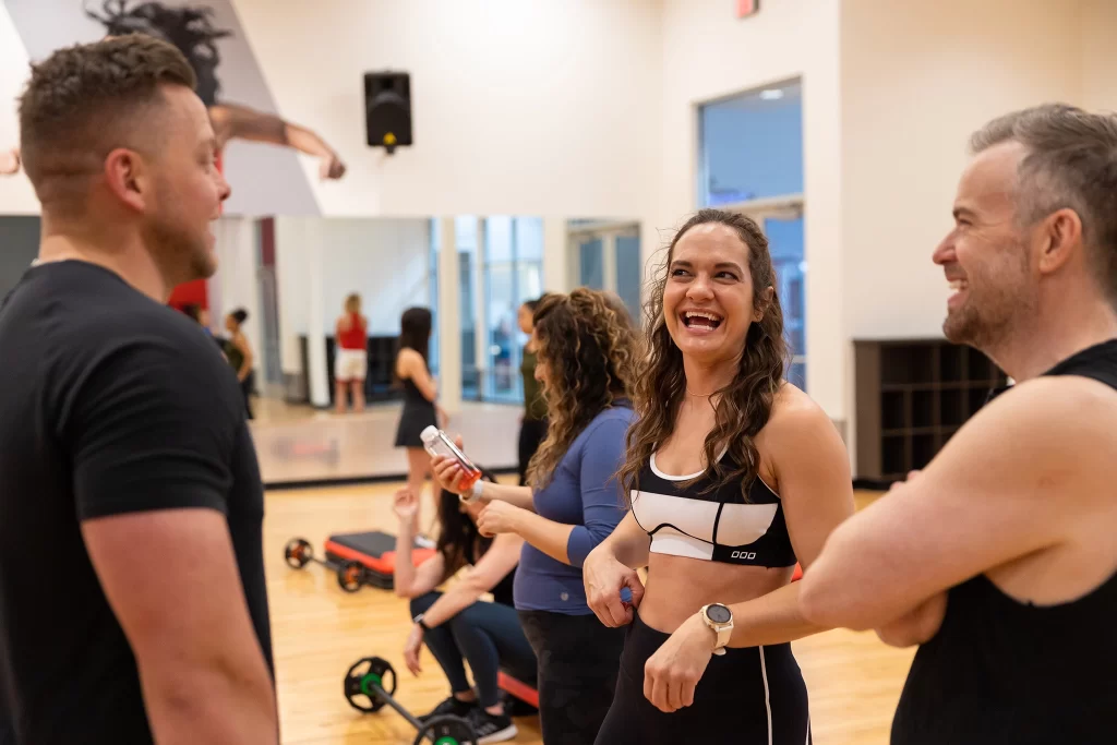 Community of athletes talking before a group fitness class at VASA Fitness