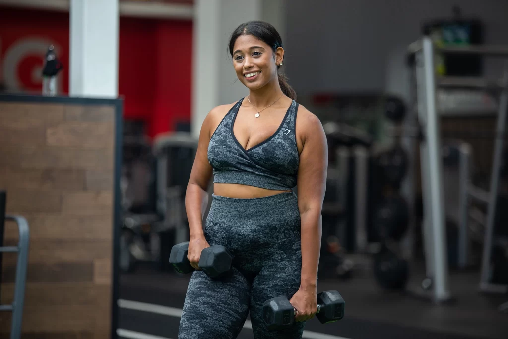 Female athlete working out with dumbbells at VASA Fitness
