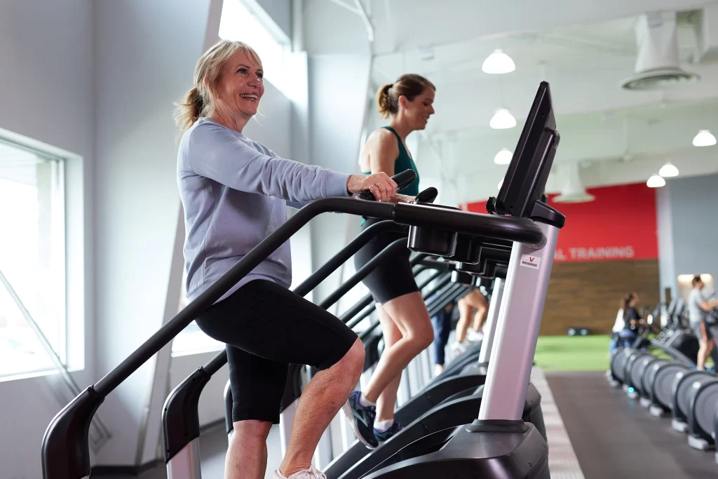 Female athletes on stair steppers in VASA Fitness' cardio deck